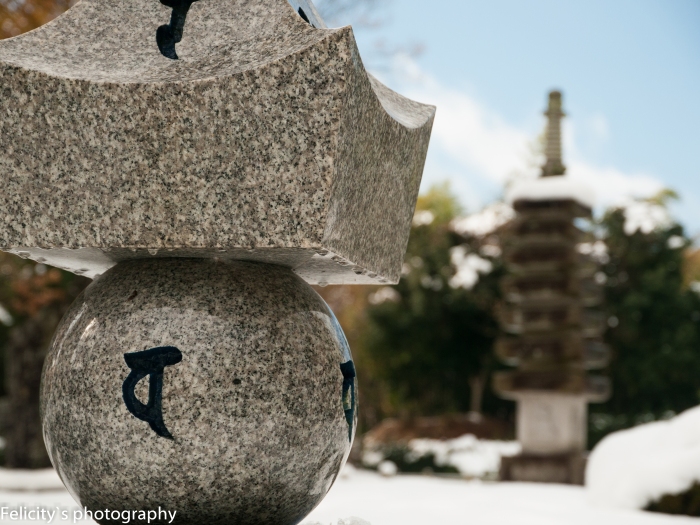 Stone and snow: Small Buddhist pagoda dominate the otherwise featureless hill-top.  
